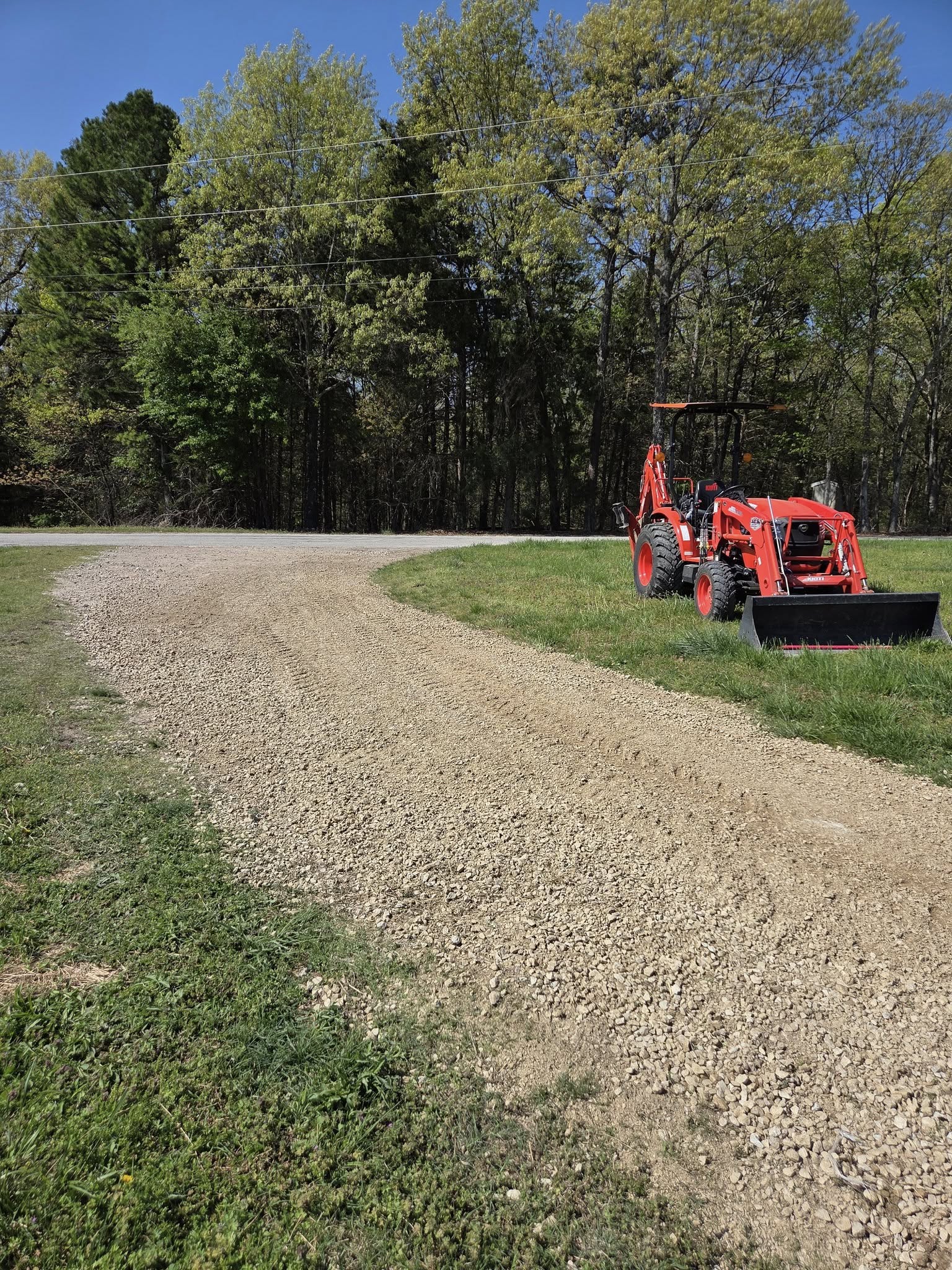 excavator grading and leveling a construction site