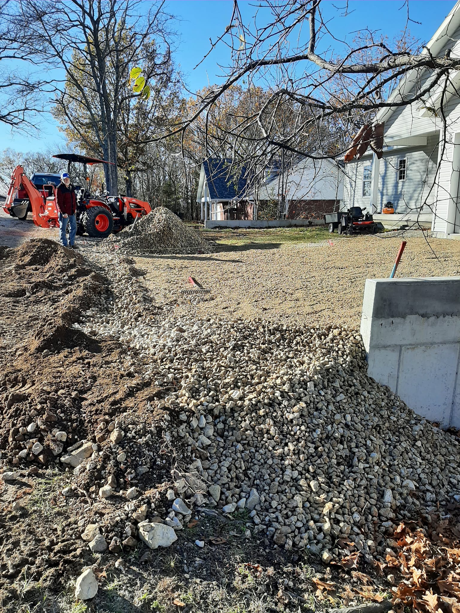 a driveway being repaired with a new gravel base