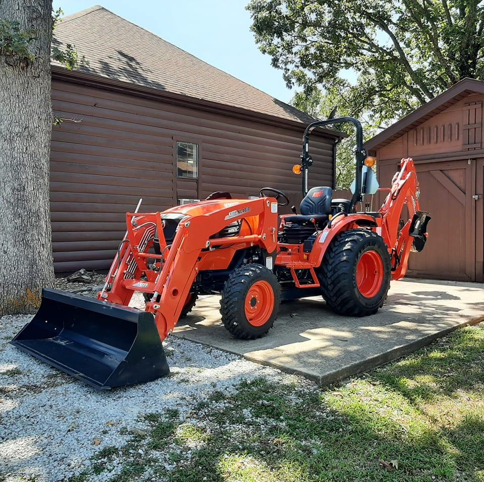 an excavator sitting on a concrete pad